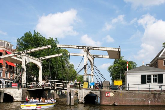 Tijdens het plastic vissen is er voldoende tijd om van Amsterdamse grachten te genieten. Plastic Whale vissen in de Amsterdamse grachten , de dag na Pride Amsterdam